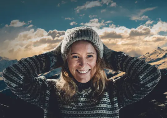 Konseptbilde for Valdres Folkehøyskole. Bilde av ei blid jente med Valdresnatur i bakgrunn